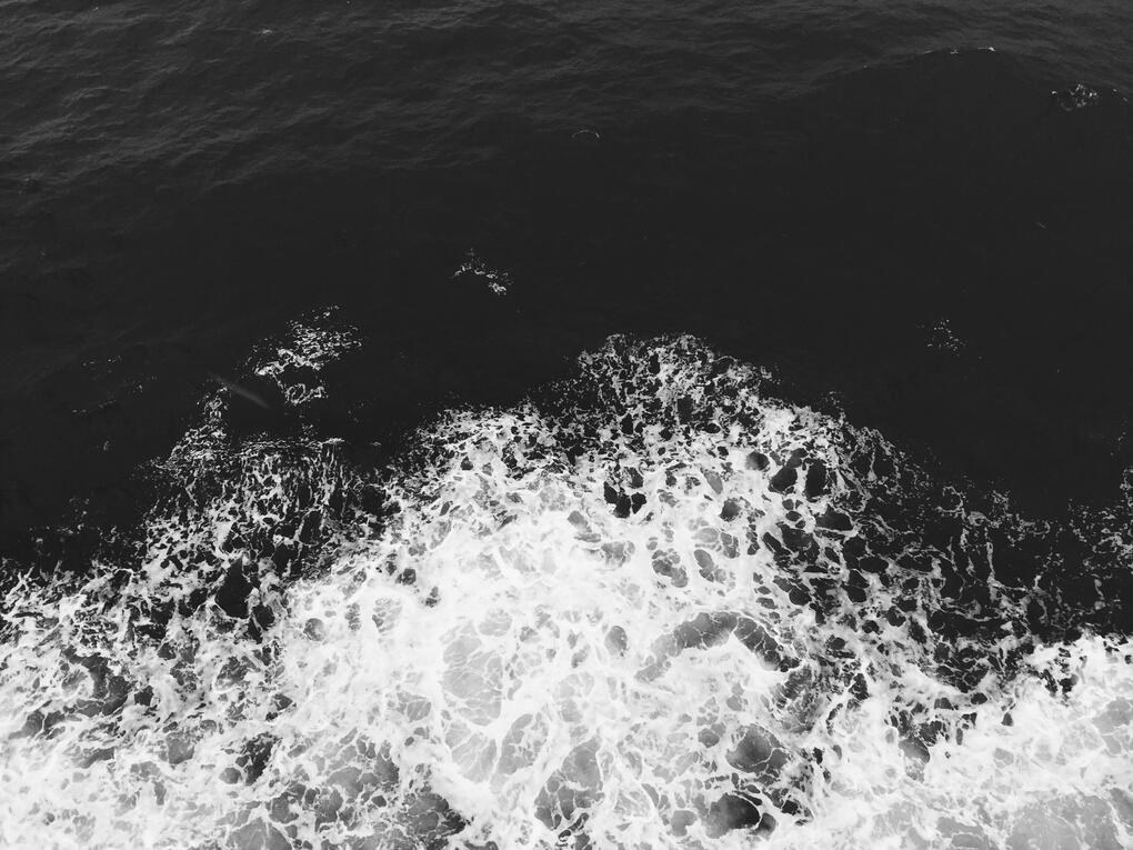 black and white photo of crashing waves